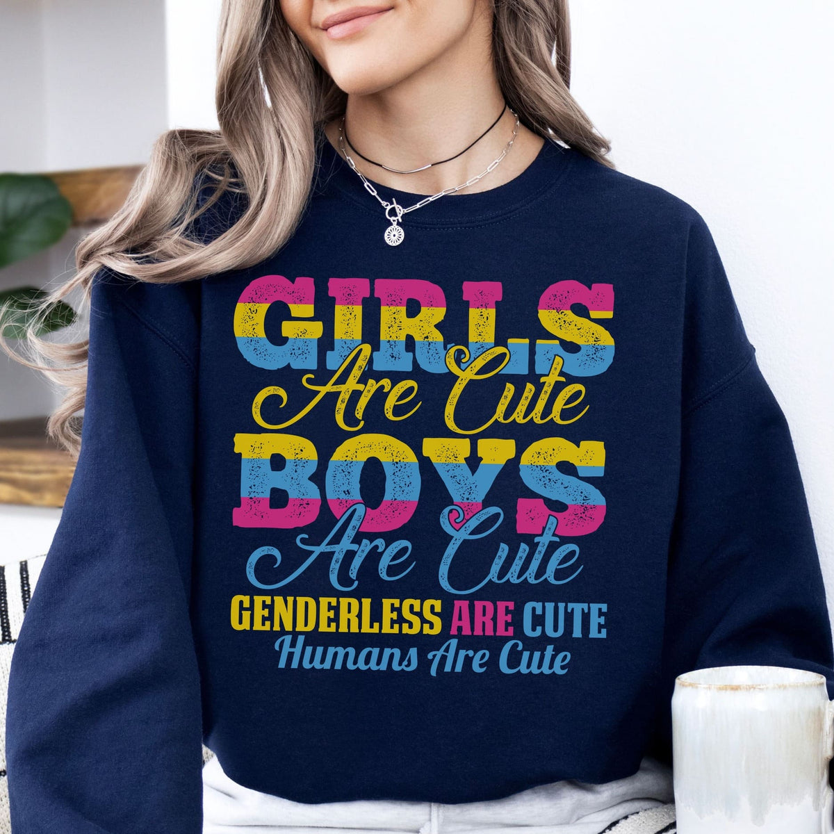 Person wearing a navy blue pansexual sweatshirt with colorful text message.
