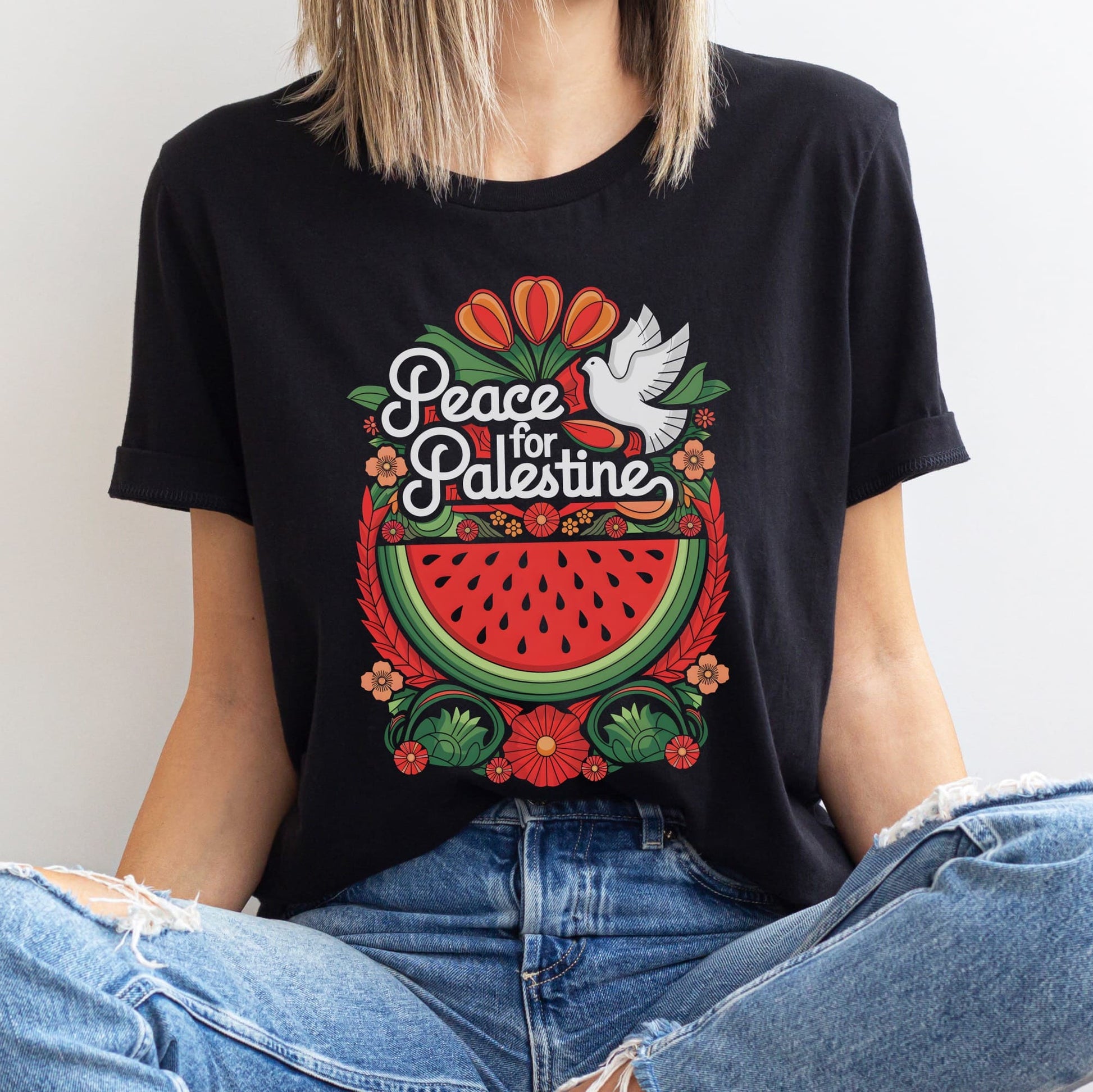 Person wearing a black t-shirt with 'Peace for Palestine' design featuring a watermelon and dove.