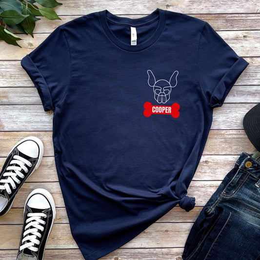 Navy blue t-shirt with a dog graphic and 'Cooper' text on a wooden surface with shoes and jeans: Personalized Puppy Play Shirt, Custom Name Pet Pride Tee, Human Puppy T-Shirt, Petplay Merch, Gift For Pup & Handler, Puppy Hood Design