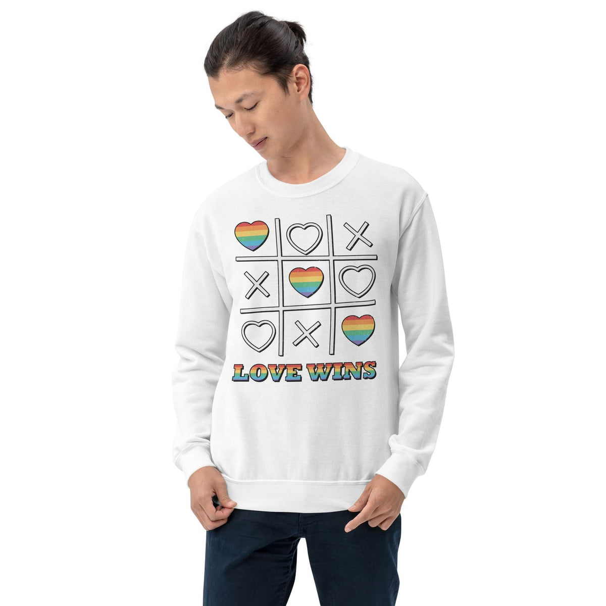Person wearing a white LGBT pride sweatshirt with rainbow heart and cross design and 'LOVE WINS' text on a white background