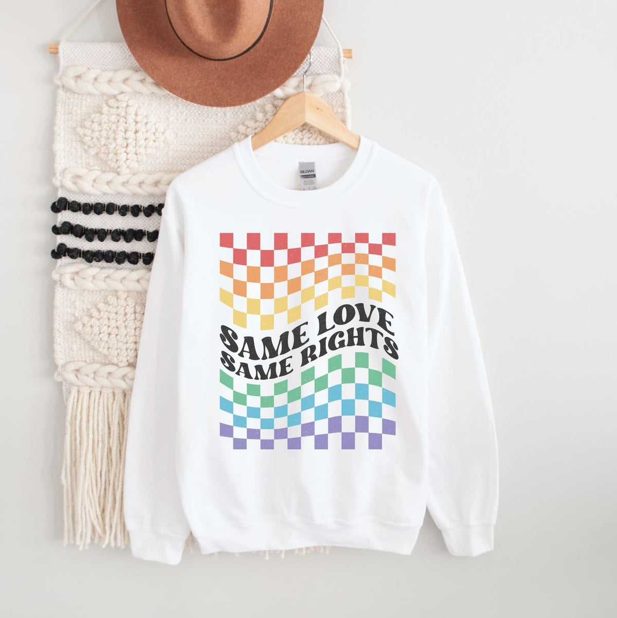 White LGBT pride sweatshirt with rainbow checkered pattern and 'Same Love Same Rights' text on a white background.