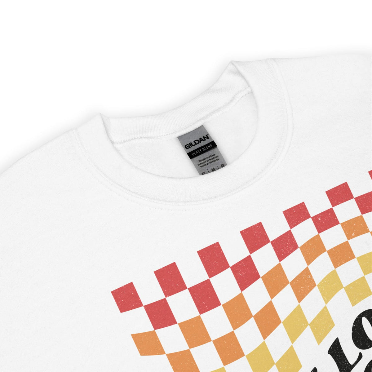 Pride sweatshirt detail with a colorful checkered pattern and 'Gildan' label on a white background