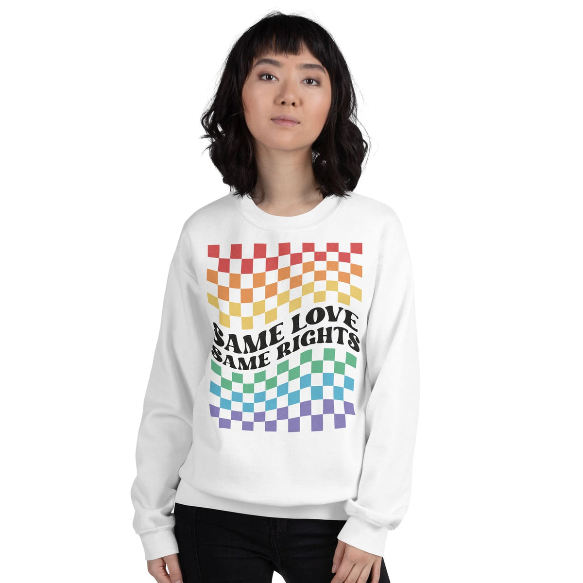 Person wearing a white LGBTQ pride sweatshirt with rainbow checkered pattern and text on a white background