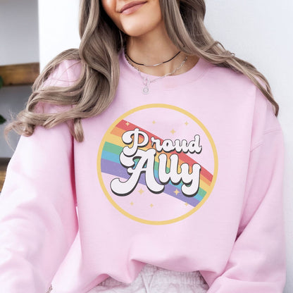 Person wearing a pink ally pride sweatshirt with a rainbow and text design.
