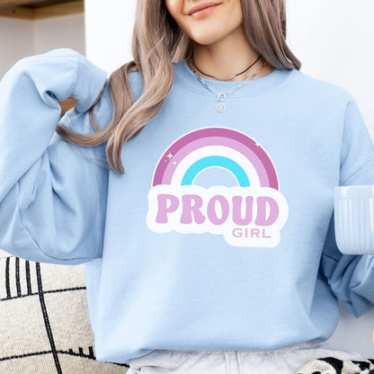 Light blue sweatshirt with rainbow and 'PROUD GIRL' text worn by a person.