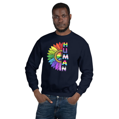 Person wearing a navy LGBT pride sweatshirt with a colorful 'HUMAN' design on a white background