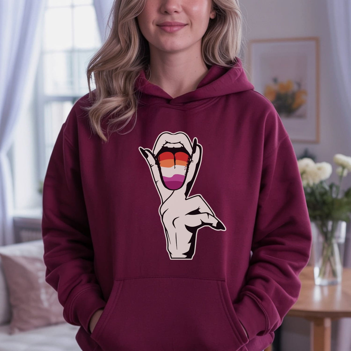 Person wearing a maroon hoodie with a suggestive lesbian design.