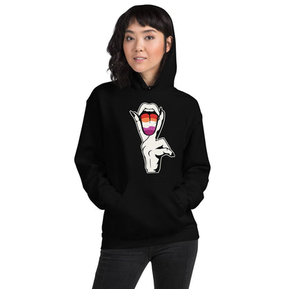 Person wearing a black hoodie with a suggestive lesbian design on a white background