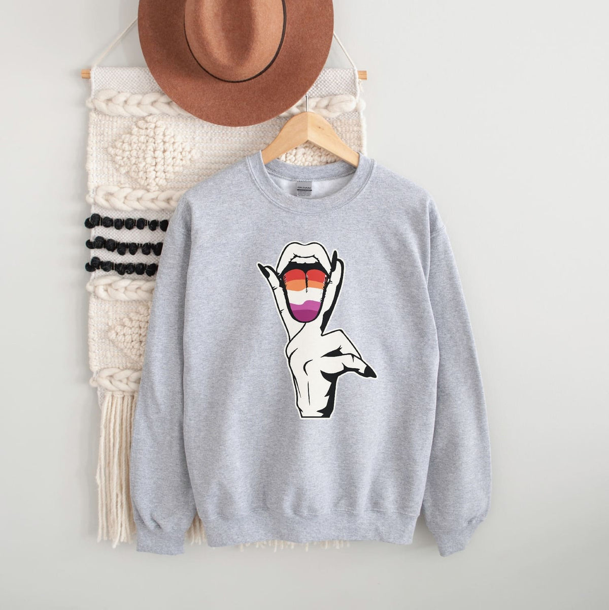 Gray lesbian sweatshirt with a rude wlw hand design on a white background