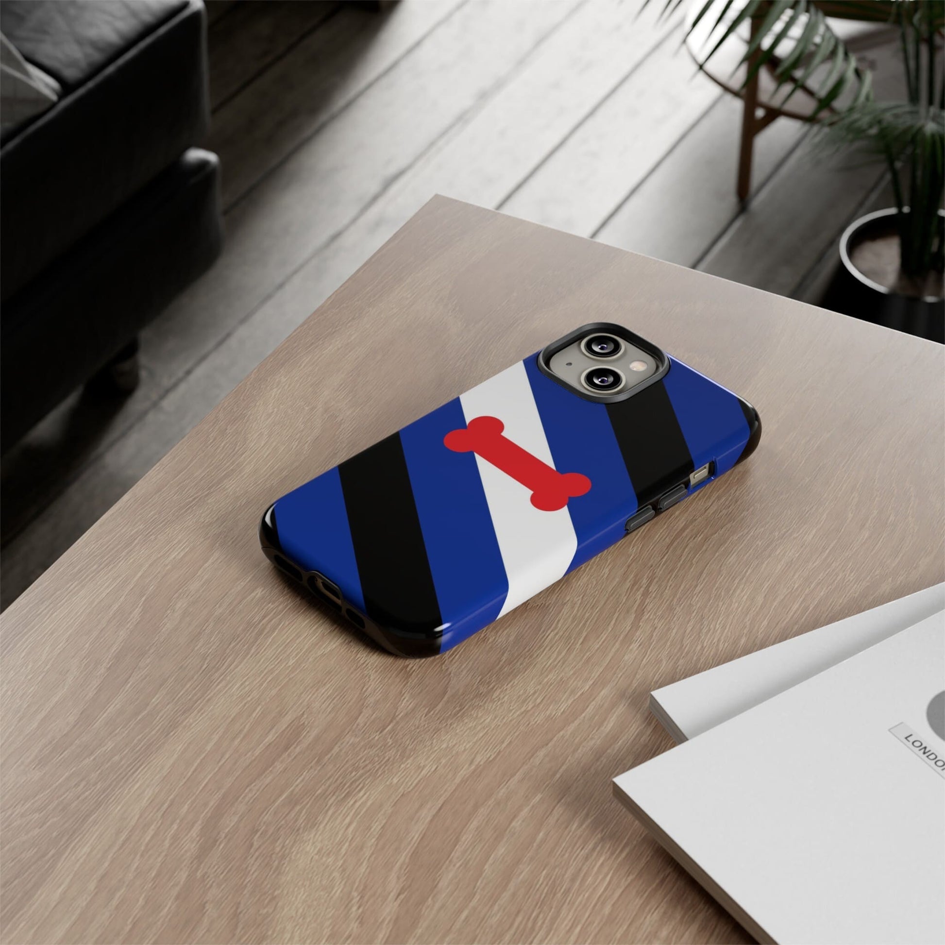 Puppy play pride flag phone case, on table