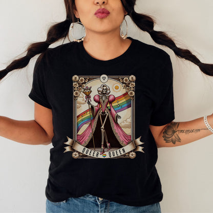 Person wearing a black t-shirt with a graphic design featuring a rainbow flag and text: LGBTQ Queer Queen Shirt, Spooky Gay Skeleton Tarot Card Tee, Whimsical Goth LGBT Pride T-Shirt, Witchy Vibes Tshirt, Funny Occult Gift