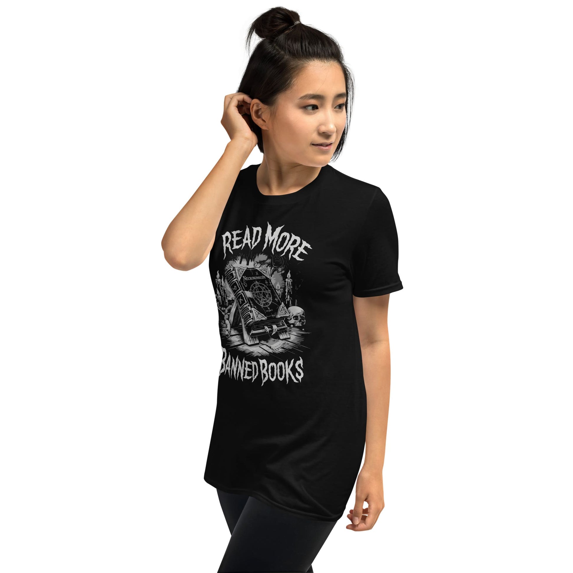 Person wearing a black t-shirt with 'Read More Banned Books'  Necronomicon text and graphic design.