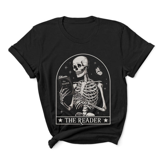 Black t-shirt with a skeleton reading a book graphic and 'The Reader' text on a white background