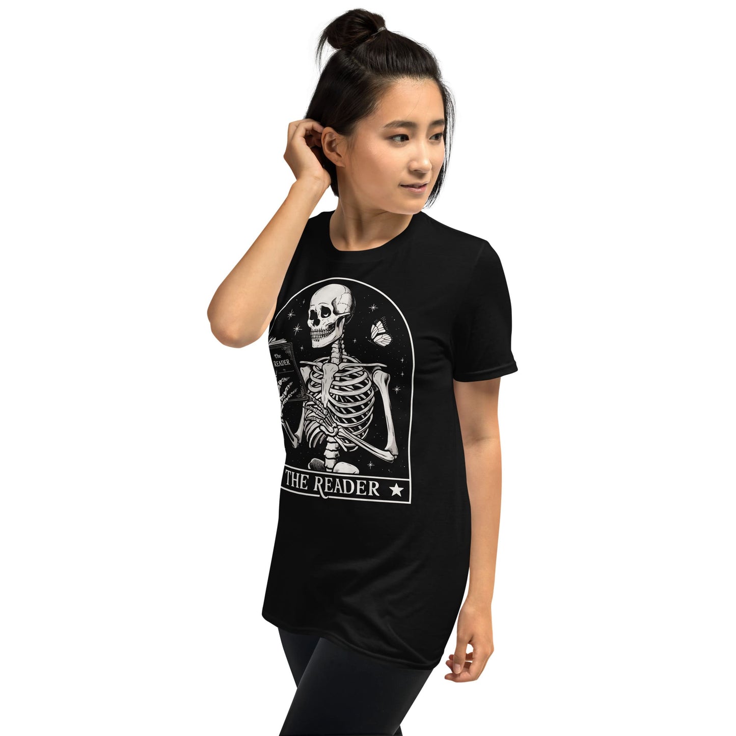 Person wearing a black t-shirt with a skeleton design and 'The Reader' text on a white background