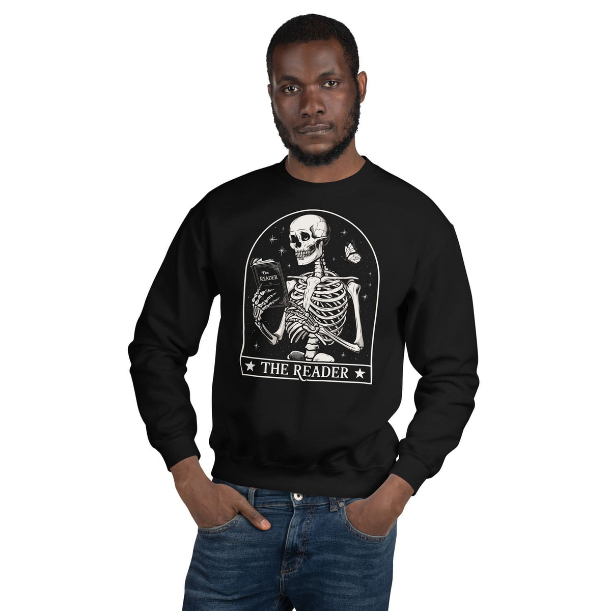 Book reader wearing a black sweatshirt with a skeleton design and 'The Reader' text on a white background