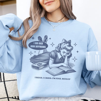 Person wearing a light blue bookish sweatshirt with a graphic design and text.