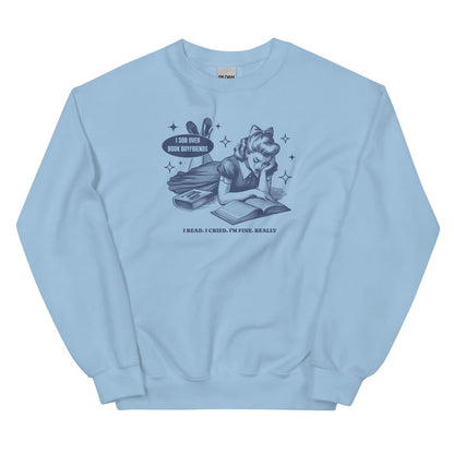Light blue sweatshirt with graphic design of a girl reading a book and text on a white background