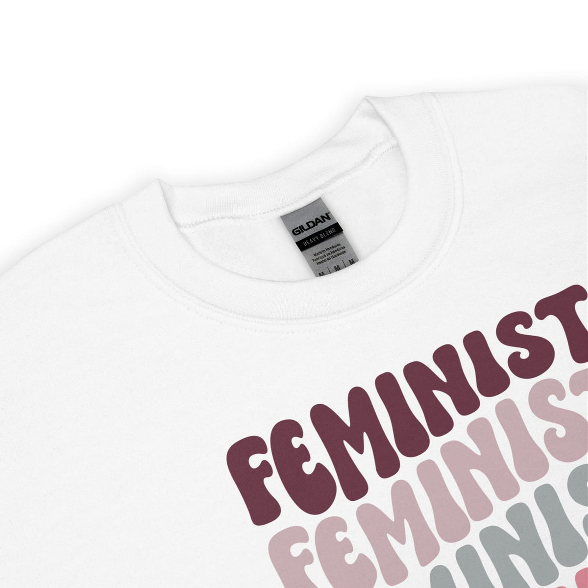 White sweatshirt with 'Feminist' text in various colors on a white background