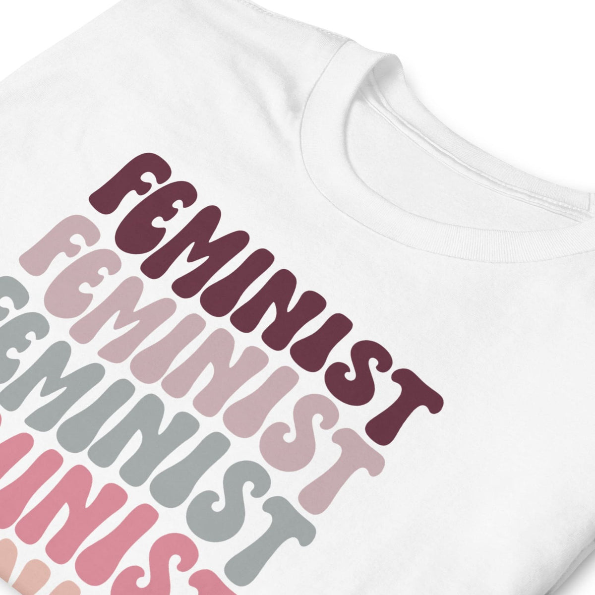 White shirt with 'Feminist' text in various colors on a white background
