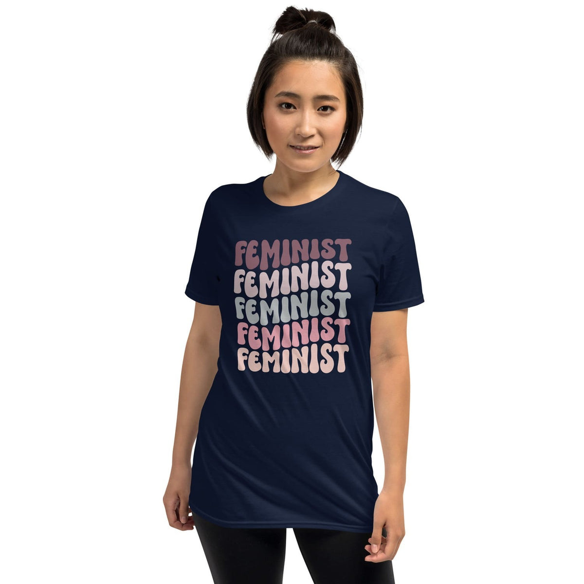 Person wearing a navy blue t-shirt with 'FEMINIST' printed in pink multiple times on a white background