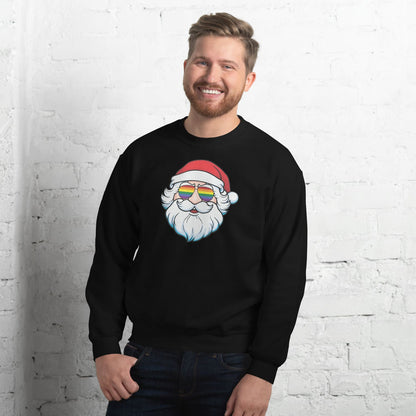 Man wearing a black sweatshirt with a pride Santa Claus design featuring rainbow lgbtq glasses against a white brick wall.