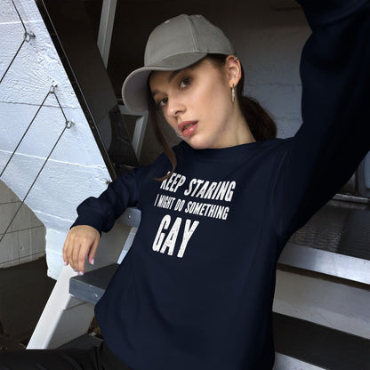 Person wearing a navy blue funny gay sweatshirt with text, sitting on steps.
