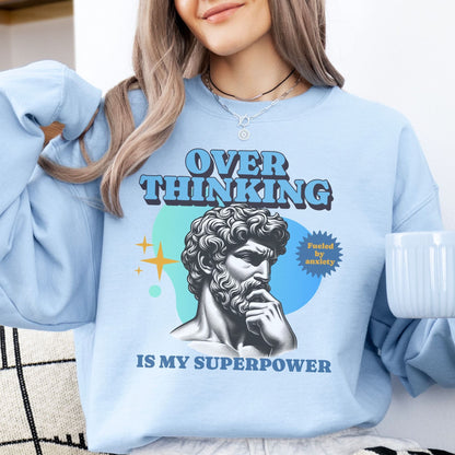 Person wearing a light blue anxiety sweatshirt with a graphic design and text.