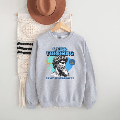 Gray anxiety sweatshirt with a graphic design and text, hanging on a wooden hanger against a white background.