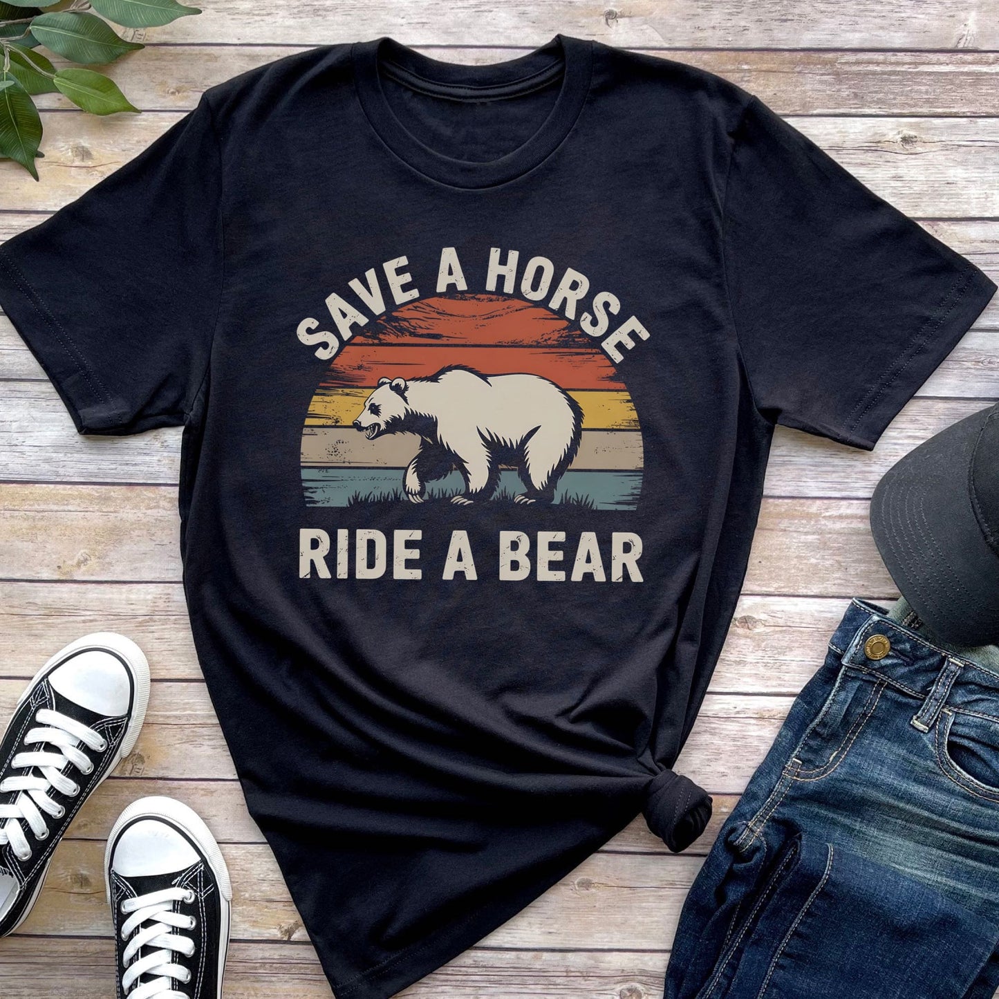 Black t-shirt with bear graphic and text 'Save a horse, ride a bear' on a wooden surface with shoes and jeans: Funny Gay Bear Shirt, Save A Horse Ride A Bear Tee, MLM Rodeo Cowboy Tshirt, Gay Male Homosexual Apparel, Country Pride Gift For Boyfriend