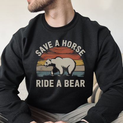 Person wearing a black pride sweatshirt with a graphic of a bear and text 'Save a horse, ride a bear'.