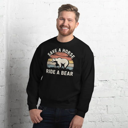 Man wearing a black bear pride sweatshirt with a graphic and text against a white brick wall.