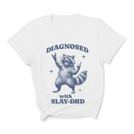 White t-shirt with a raccoon graphic and text on a white background: Funny ADHD Shirt, Unhinged Raccoon Tee, Dumb Y2K meme Neurodivergent T-Shirt, Neurospicy Gift For AuDHD, Mental Health Awareness