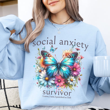 Person wearing a light blue social anxiety sweatshirt with butterfly design and text about social anxiety.