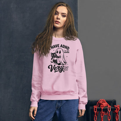 Person wearing a pink sweatshirt with a spooky ADHD design on a dark background