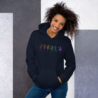 Woman wearing a navy hoodie with lgbtq rainbow dancing skeletons against a gray and white background