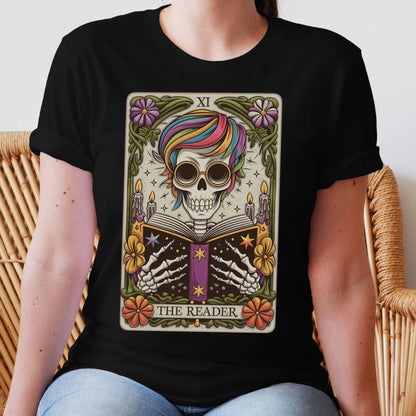 Person wearing a black t-shirt with a colorful skull and tarot card designThe Reader Skeleton Shirt, Tarot Card Bookish Halloween Tee, Subtle Pride Rainbow Seasonal T-Shirt, Mystical Gay Queer Spooky Reading Gift
