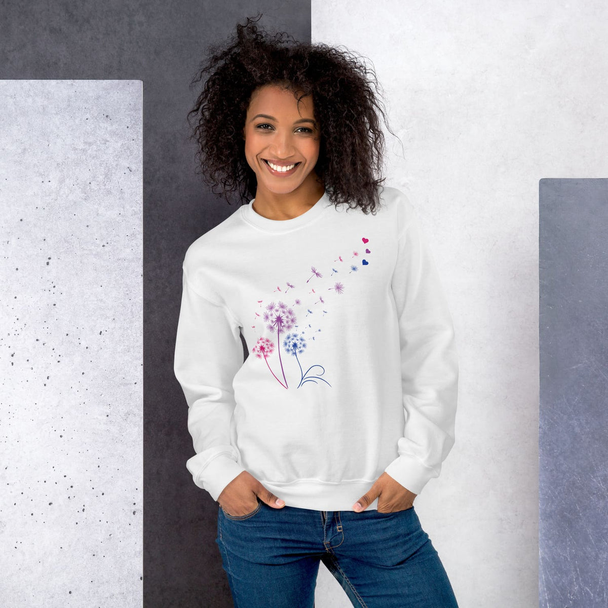 Woman wearing a white bisexual sweatshirt with a floral design against a gray and white background