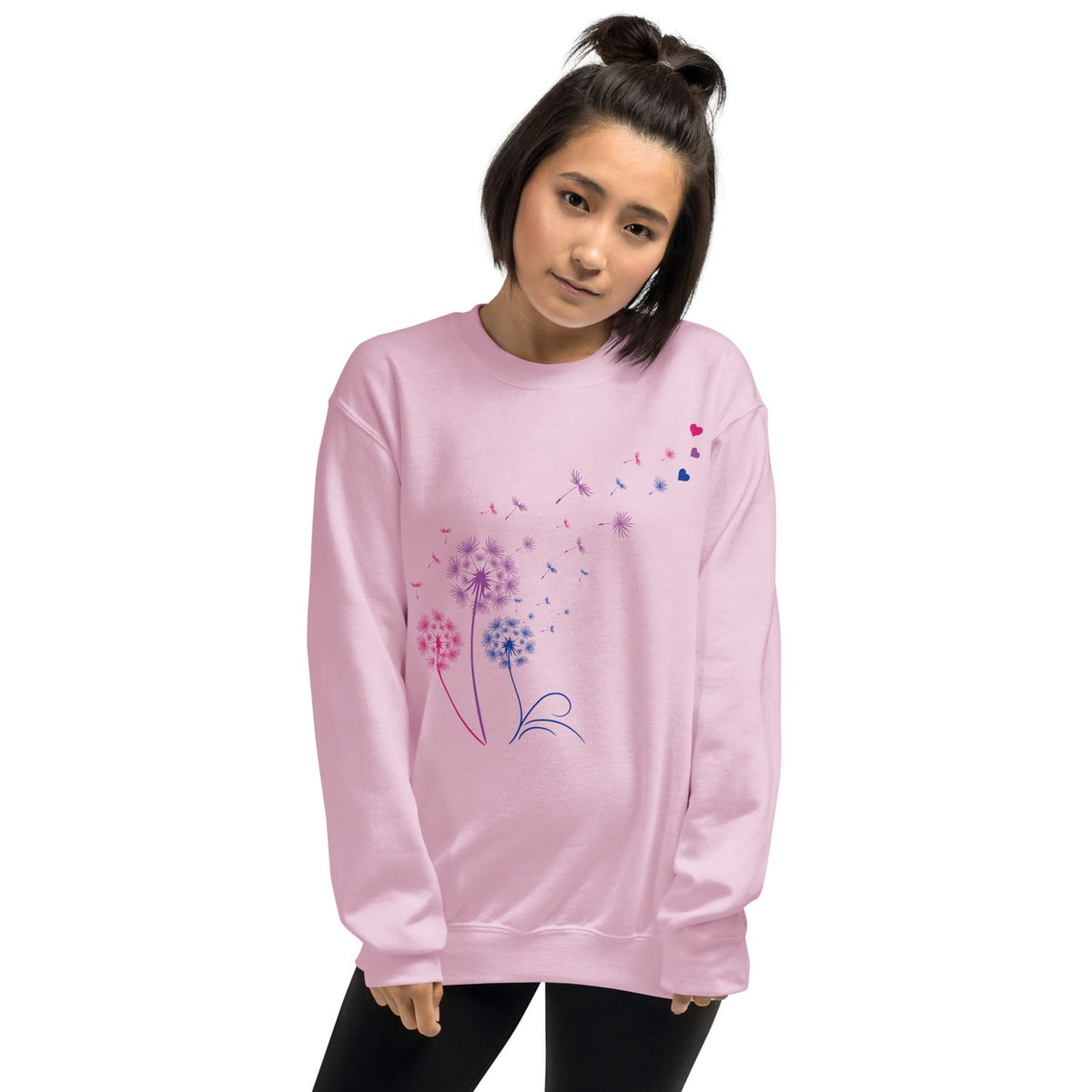 Person wearing a pink bisexual sweatshirt with floral designs on a white background
