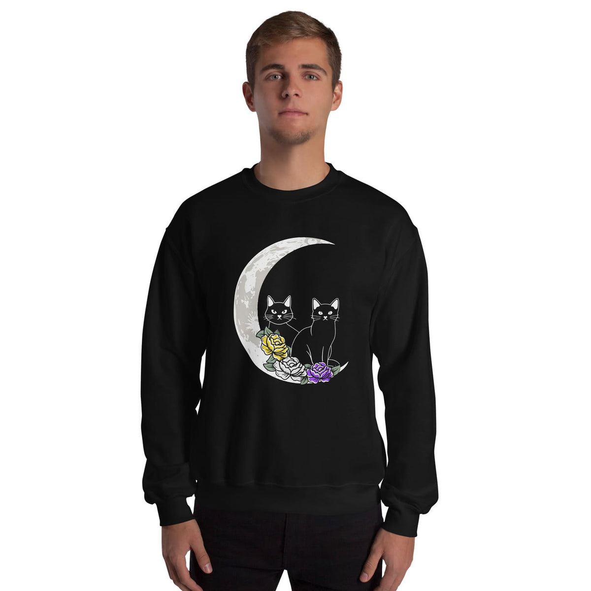 Person wearing a black NB sweatshirt with a design of two cats on a moon and flowers.
