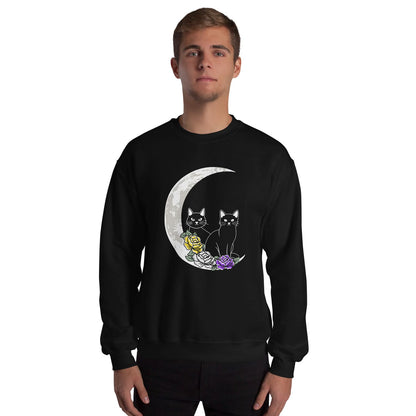 Person wearing a black NB sweatshirt with a design of two cats on a moon and flowers.