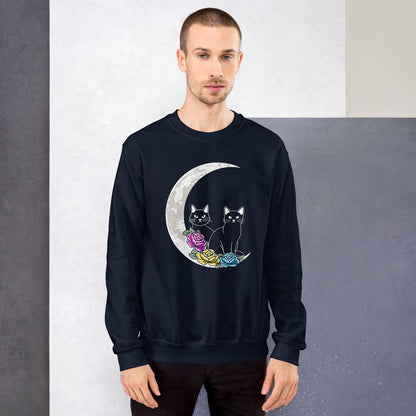 Man wearing a navy pansexual sweatshirt with a moon and cats design against a gray background