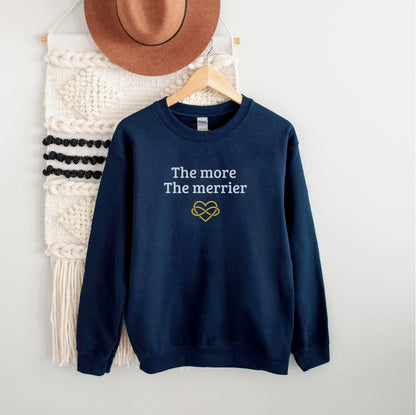 Navy blue polyamory weatshirt with 'The more The merrier' text and heart design on a white background