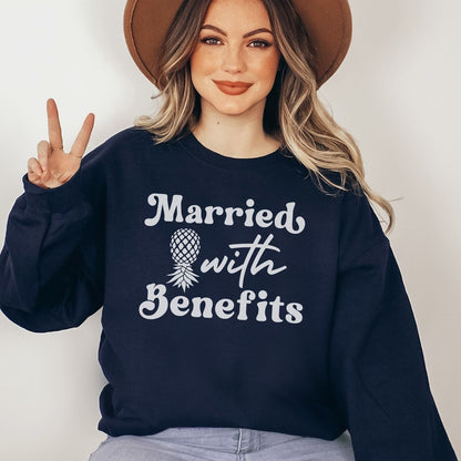 Woman wearing a navy swingers sweatshirt with 'Married with Benefits' text and a pineapple graphic.