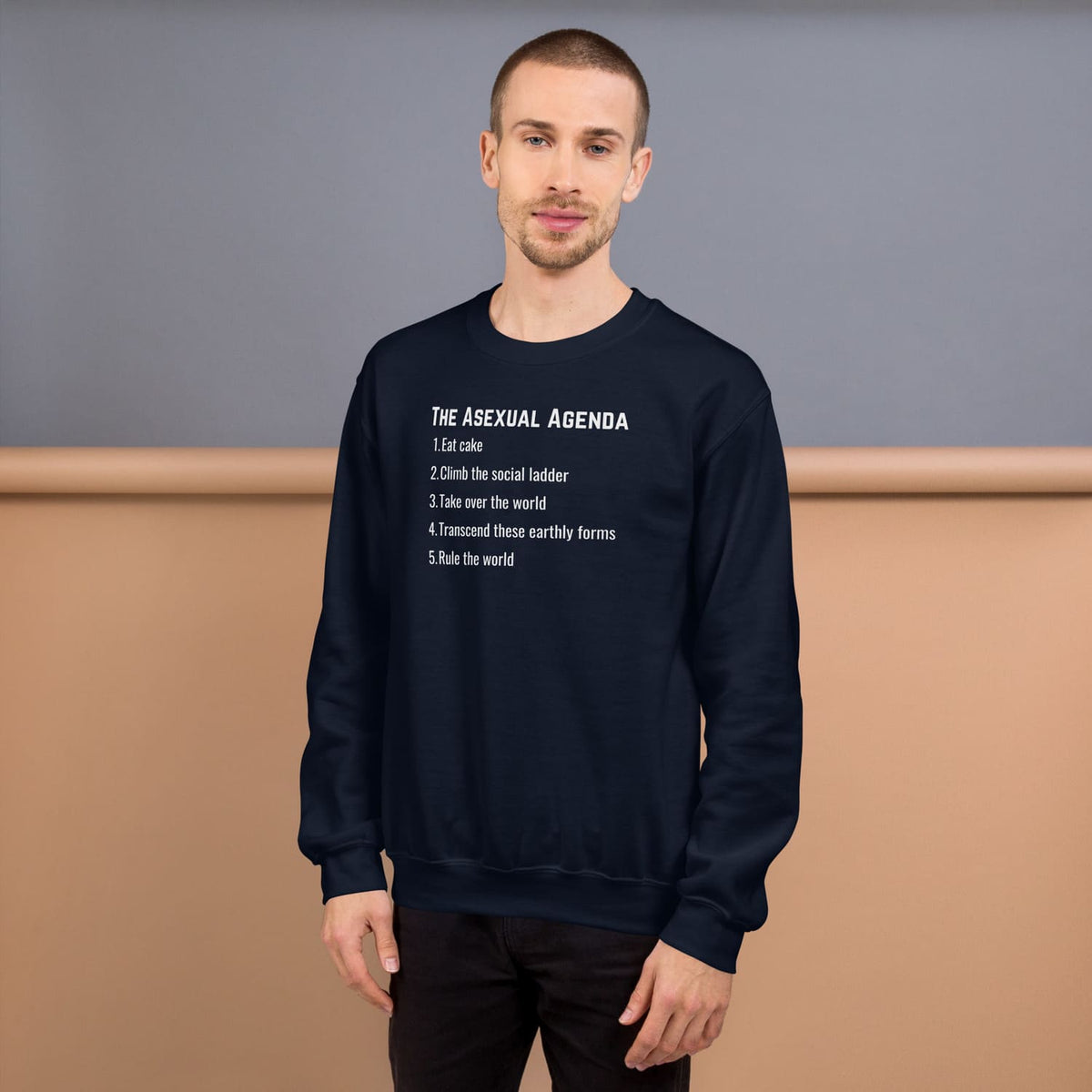 Man wearing a navy blue sweatshirt with 'The Asexual Agenda' text on a plain background