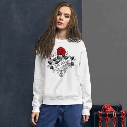 nonbinary person wearing a white feminist pronoun sweatshirt with a red rose design against a dark background