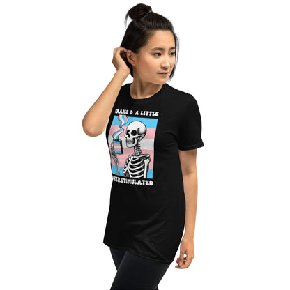 Person wearing a black t-shirt with a colorful graphic design featuring a skeleton and text: Transgender Anxiety Shirt, Overstimulated Tee, Mental Health T-Shirt, Trans Pride Skeleton Shirt, Sarcastic Neurospicy Gift For MTF Or FTM