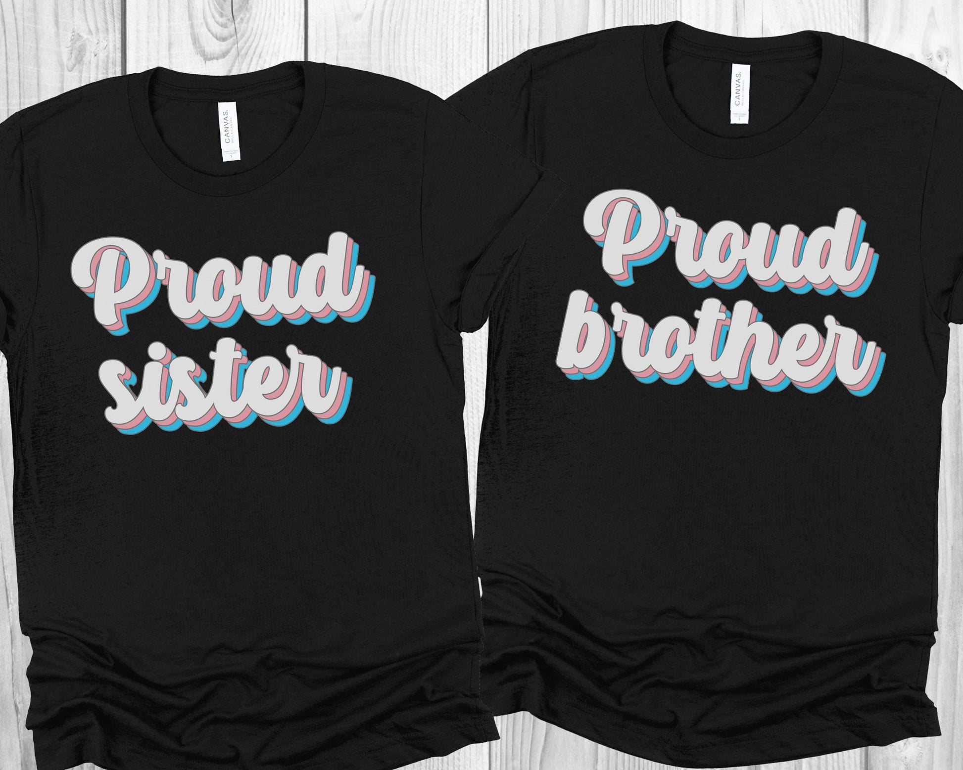 matching transgender t-shirts with 'Proud sister' and 'Proud brother' text on a wooden surface.