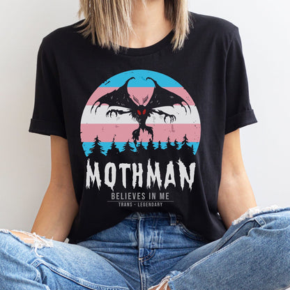 Person wearing a black t-shirt with Mothman graphic and text: Transgender Mothman Shirt, Trans Pride Cryptid Folklore Tee, Queer Mythology Legend Cryptozoology T-Shirt, Cryptidcore Weirdcore LGBT Gift