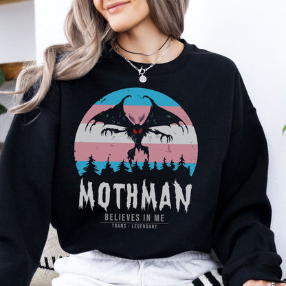 Person wearing a black transgender sweatshirt with Mothman graphic and text