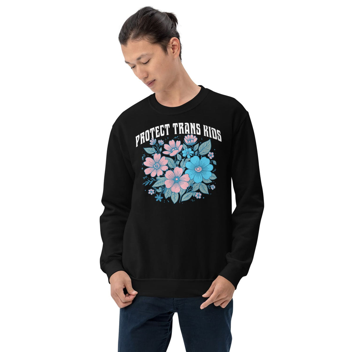 Person wearing a black transgender sweatshirt with floral design and text on a white background